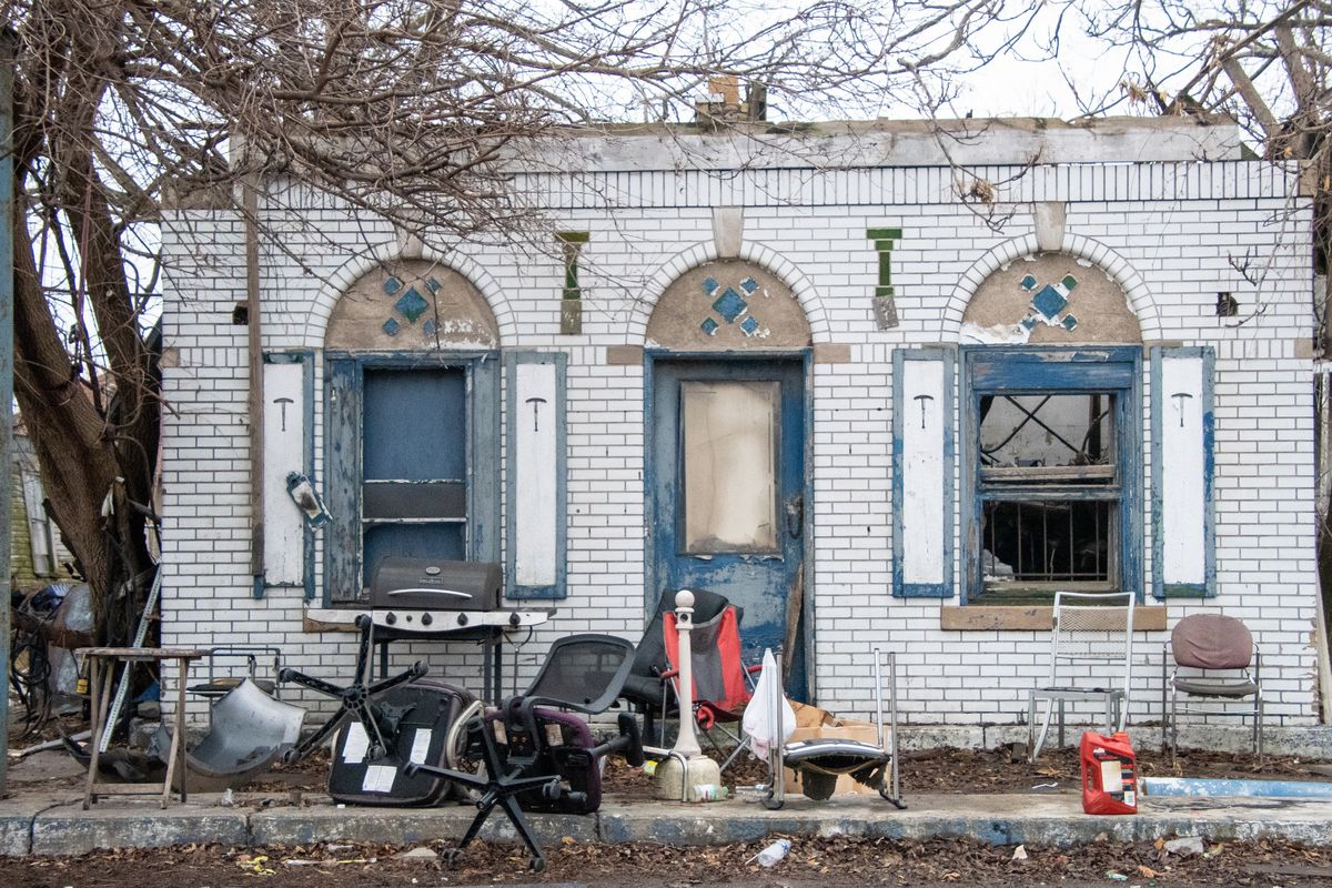 Photo of abandoned detroit home with debris in front